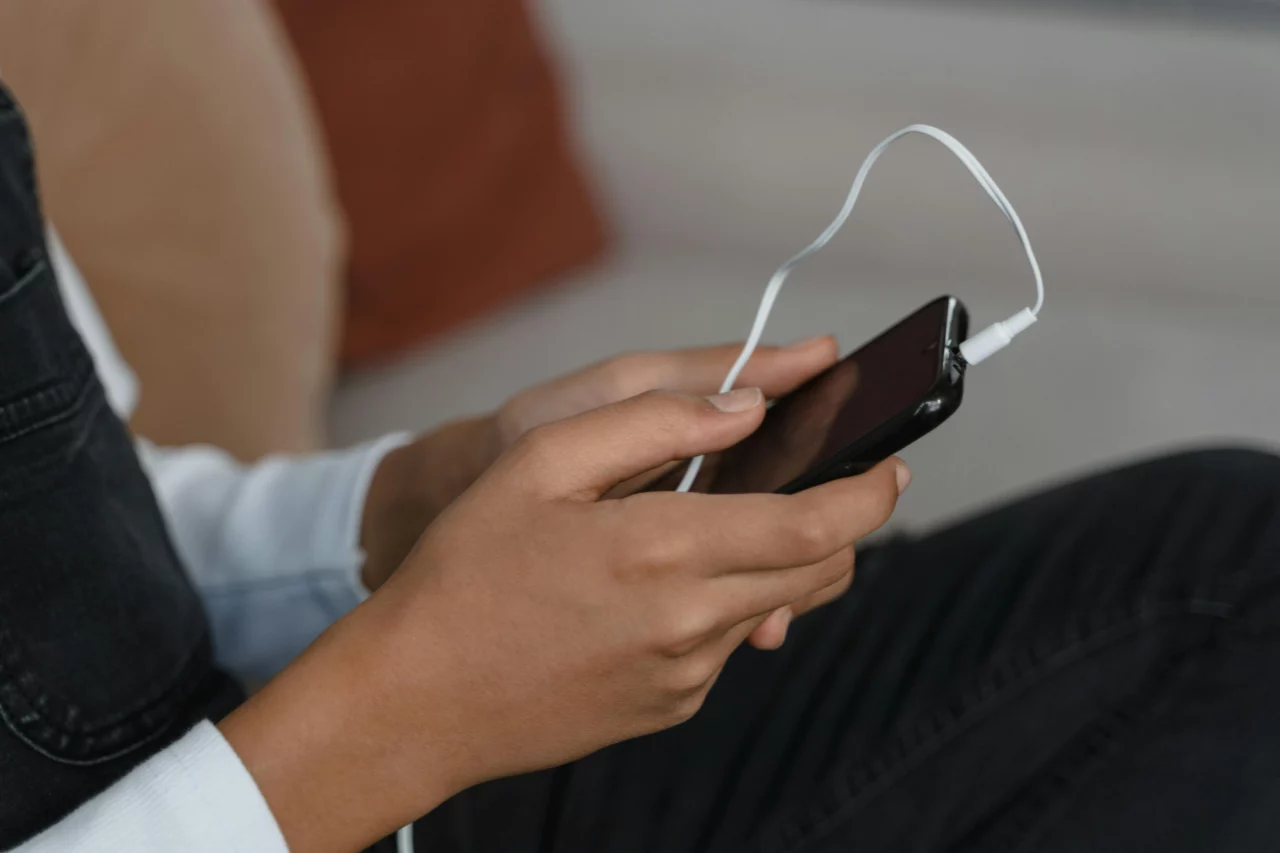 person listening to audio on mobile device